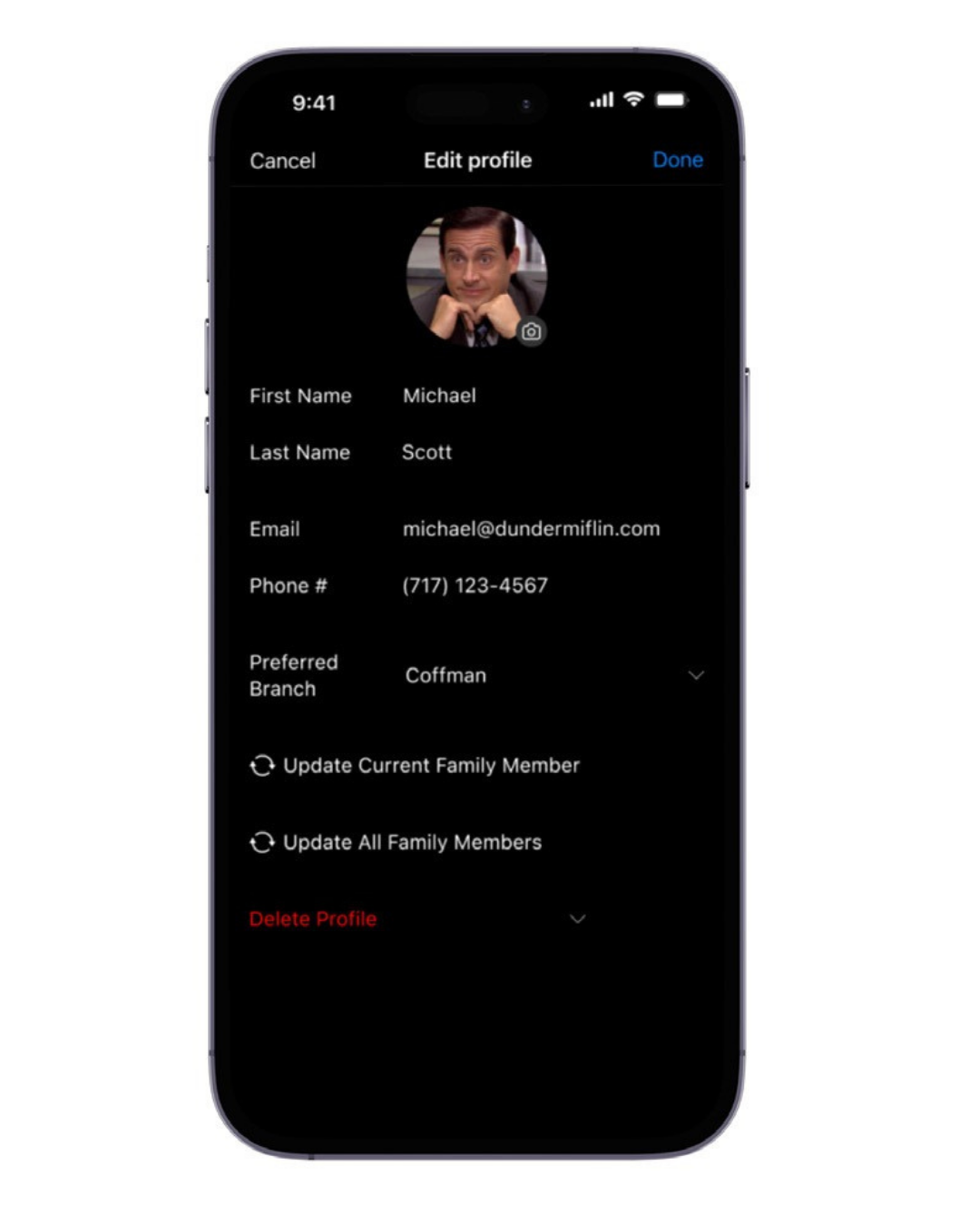 Smartphone screen displaying an “Edit Profile” page in dark mode. The profile photo shows Michael Scott. The form fields include First Name: Michael, Last Name: Scott, Email: michael@dundermiflin.com , Phone: (717) 123-4567, and Preferred Branch: Coffman. Options below include “Update Current Family Member,” “Update All Family Members,” and a red “Delete Profile” button. “Cancel” and “Done” appear at the top.
