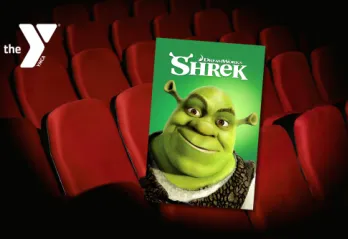 Movie theater seats with a Y logo and Shrek movie cover