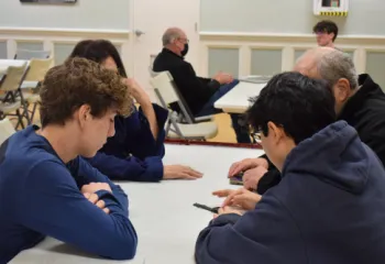 Senior Tech Buddies helping a couple with their phones