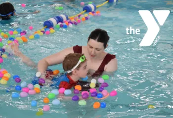 Mom and son in the pool for the Easter Egg Hunt with white Y logo overtop