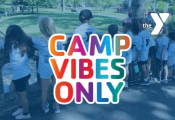 Sunshine Camp in the background with a rainbow colored "Camp Vibes Only" Logo and white Y logo.