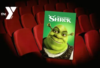 Movie theater seats with a Y logo and Shrek movie cover