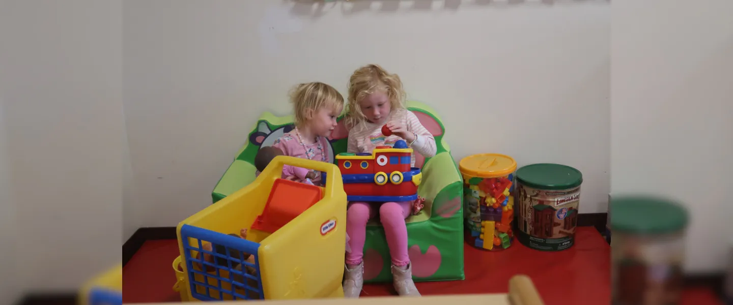 Children playing with a toy boat.