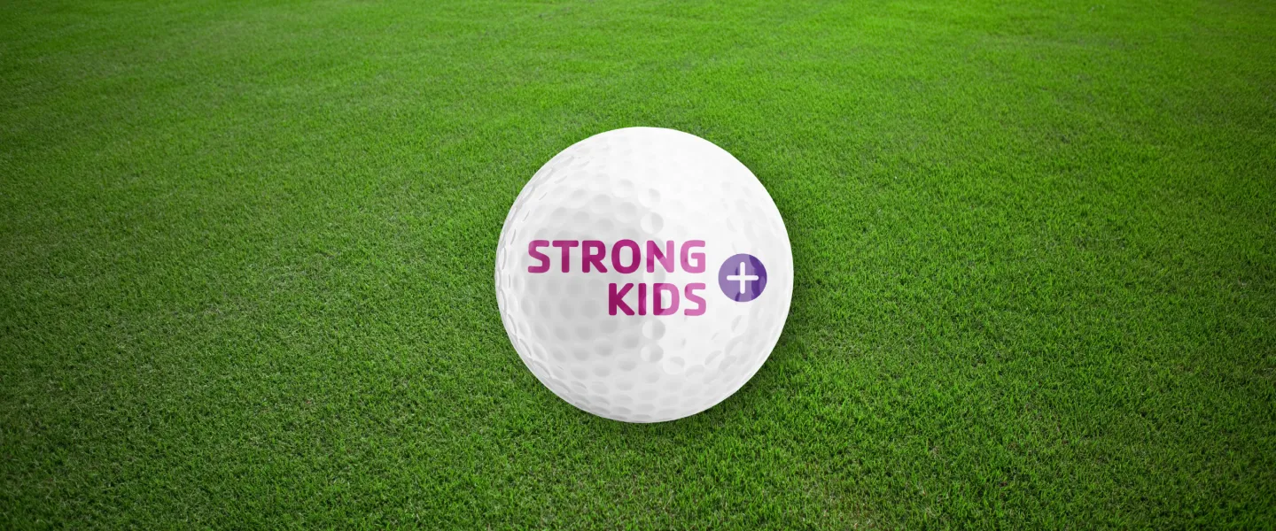 Strong Kids+ Logo on a Grassy Background