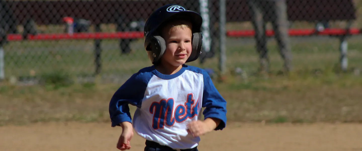 Mets T-Ball athlete running to base.