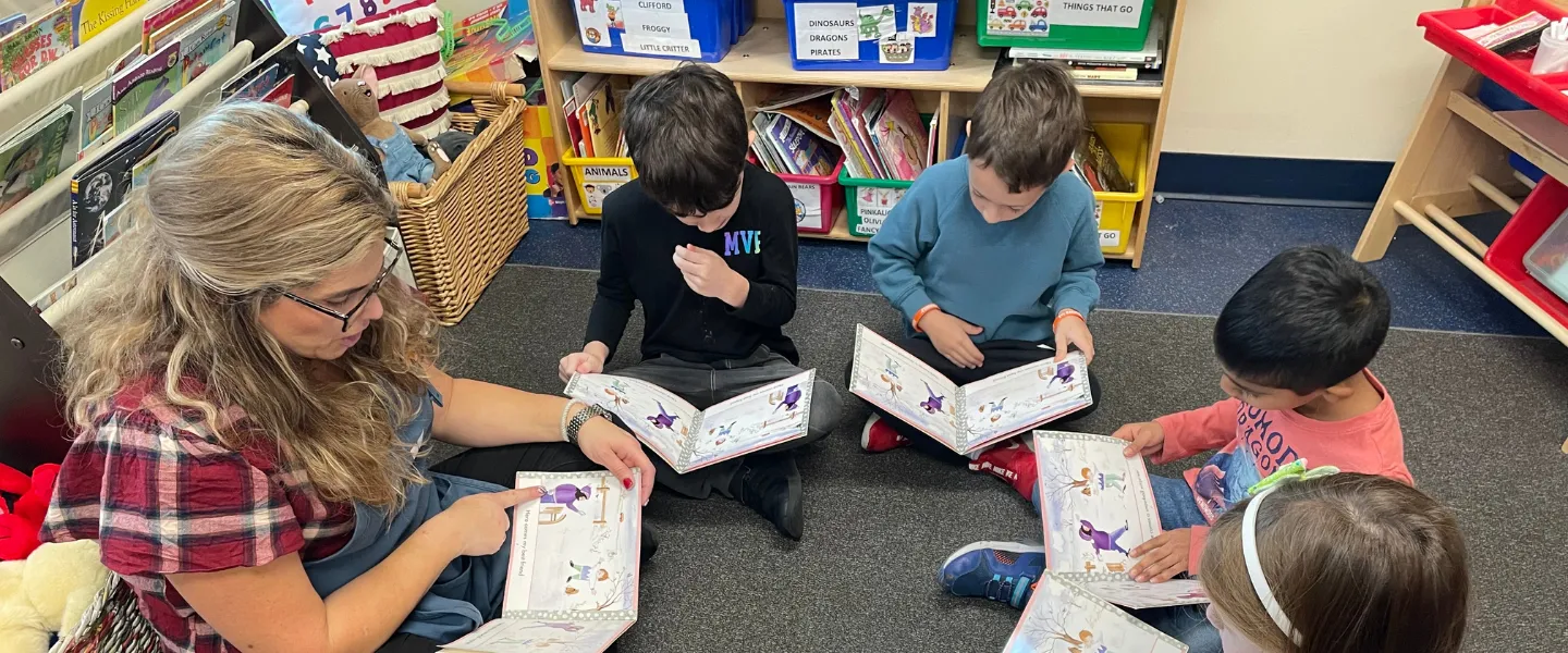 Kindergarten teacher reading with her students