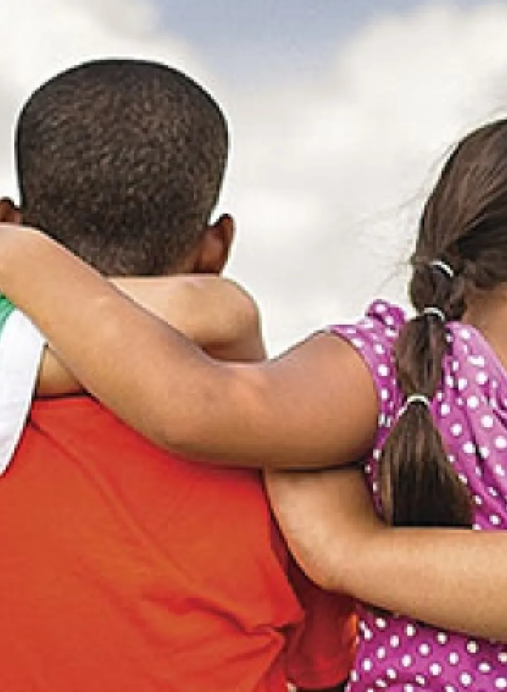 Children with their arms around one another