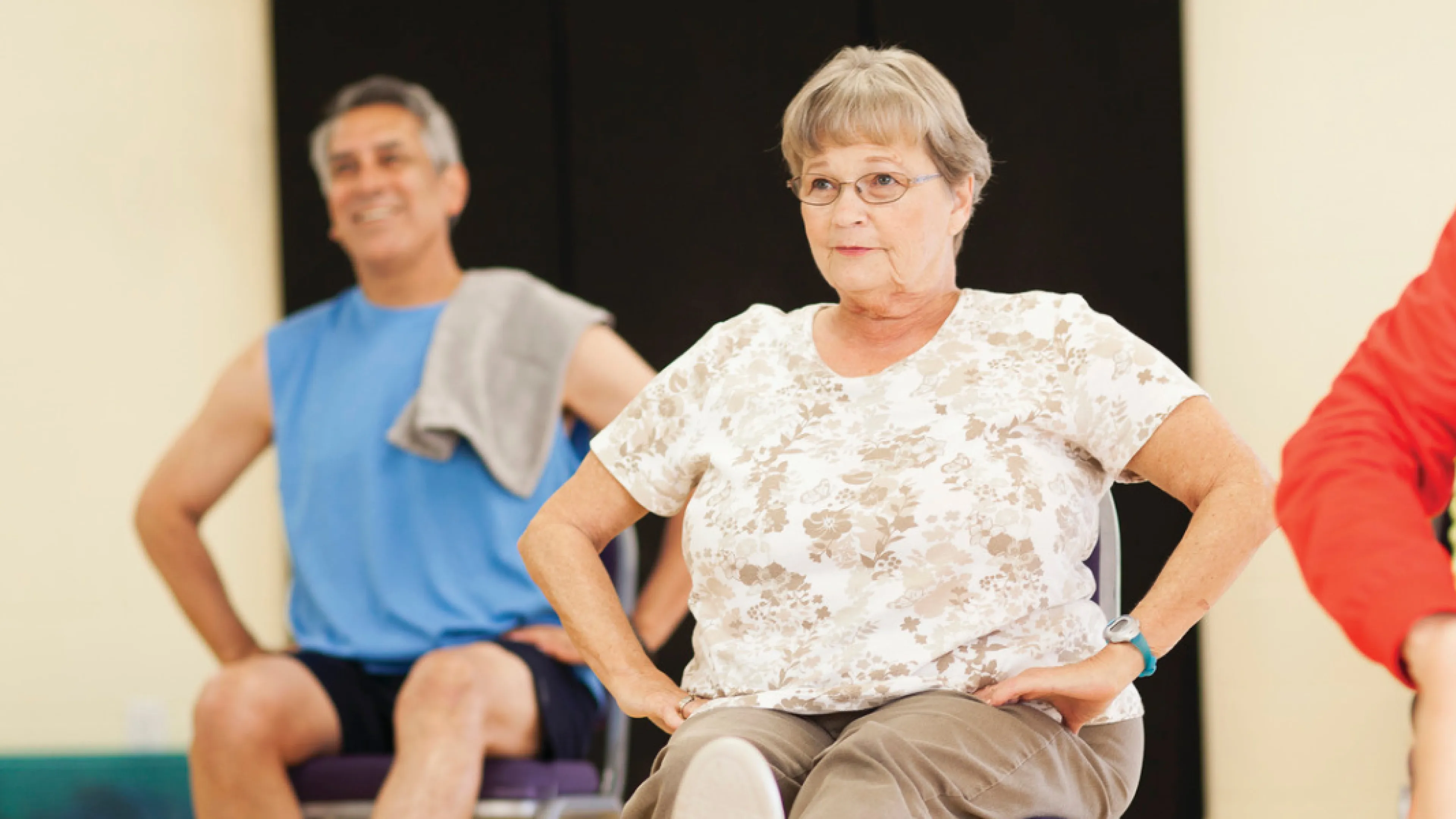 Senior woman participates in a group exercise class.