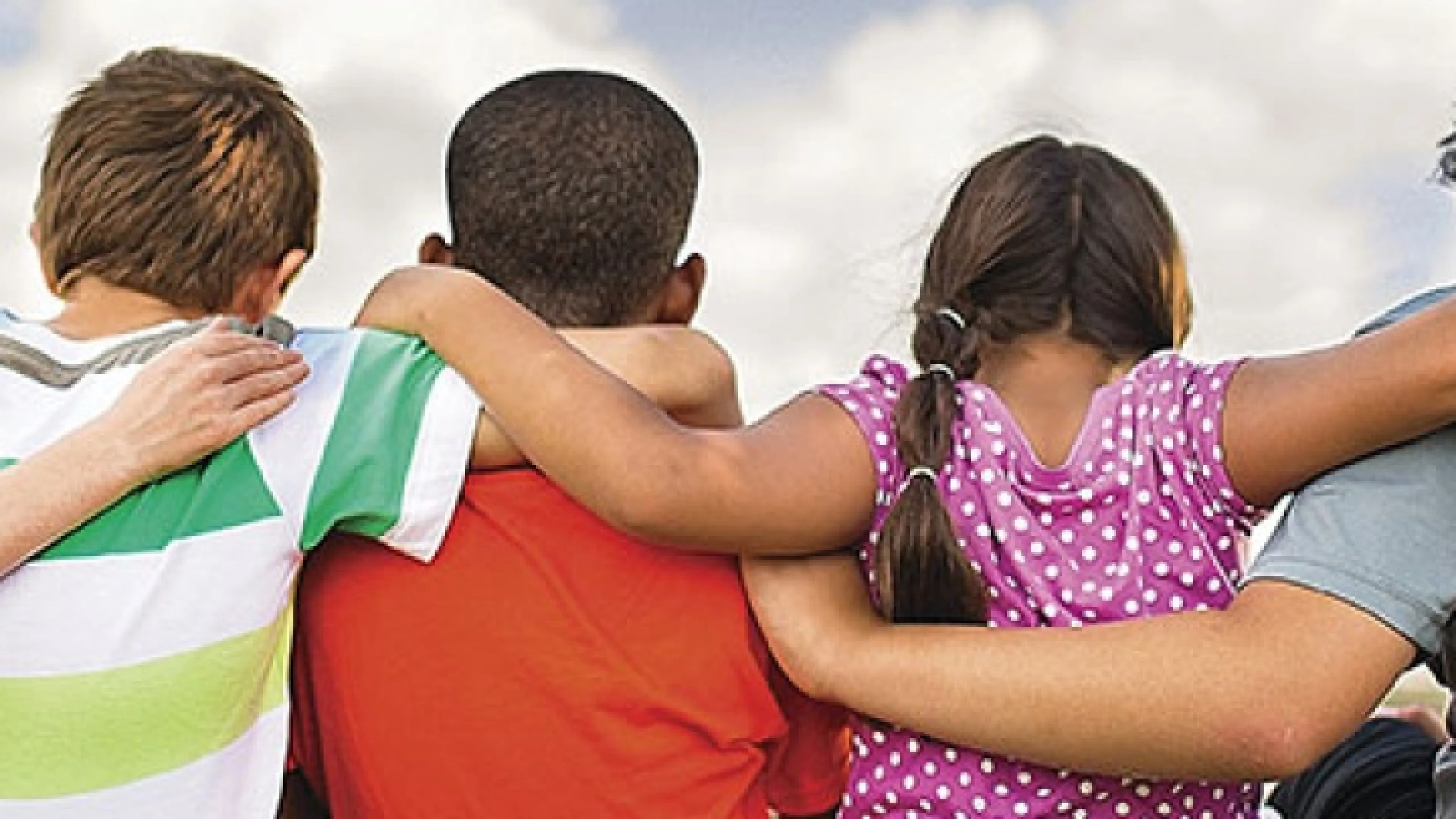 Children with their arms around one another
