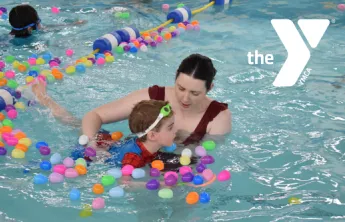 Mom and son in the pool for the Easter Egg Hunt with white Y logo overtop