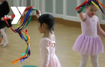Toddlers in a dance studio wave colorful ribbon props during a YMCA dance class.